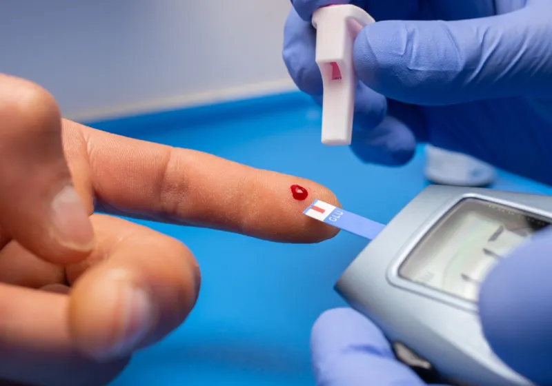 medico com luvas de borracha fazendo um exame fazendo teste de glicemia